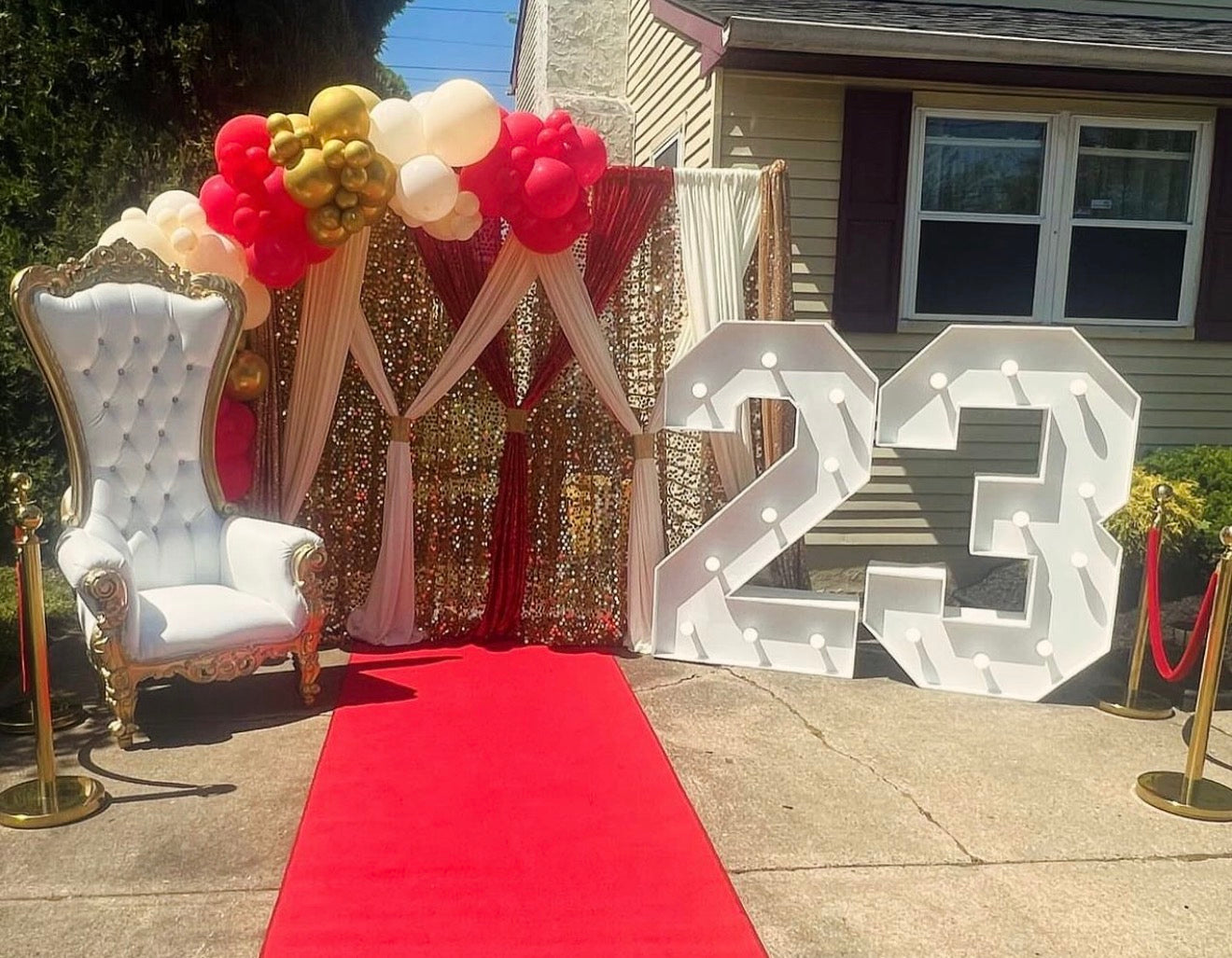 Throne Chair, 16ft Balloon Garland, Red Carpet, Stanchions, 2 Marquee Numbers & Double Backdrop